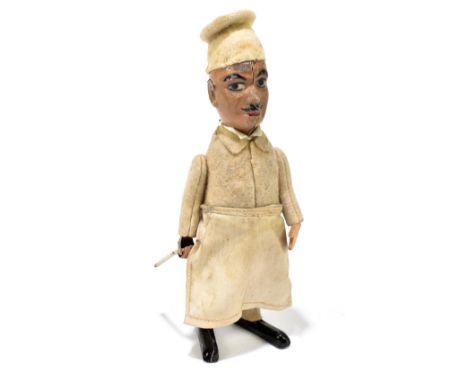 SCHUCO; a German tinplate clockwork model of a chef, with felt clothes and cotton apron, height 16.5cm.PROVENANCE: The Collec