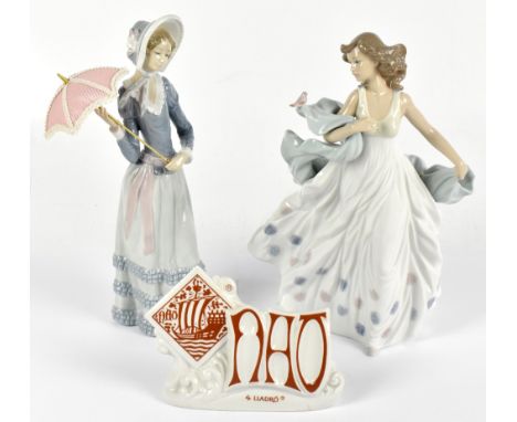 LLADRO; two figures comprising a maiden wearing a bonnet hat and holding a parasol, height 32cm, and a girl with a flowing dr