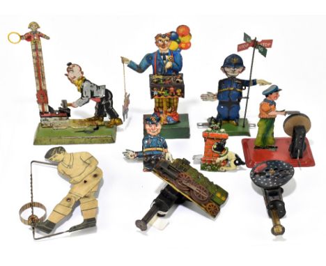 A collection of nine tinplate mechanical toys comprising a Gely mechanical 'Test your Strength' toy, height 17cm, a clockwork