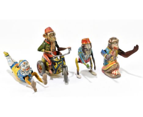 Four German tinplate clockwork toys, three modelled as monkeys and one as a clown, comprising a monkey on a trike, another wi