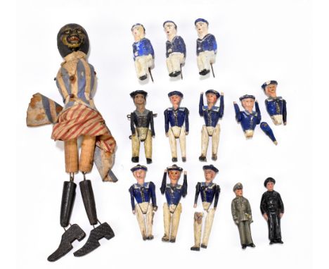 A collection of eight carved and painted wood miniature sailor dolls with jointed arms and legs, five complete, two incomplet