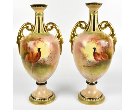 J COLEMAN FOR CROWN DEVON FIELDINGS; a pair of twin handled pedestal vases, hand painted with pheasants in a landscape scene,