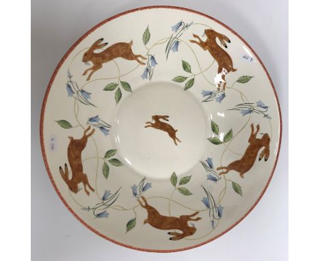A modern decorative charger painted with running hares, signed to base "L. Pettersson" and within initials / monogram "Leon a
