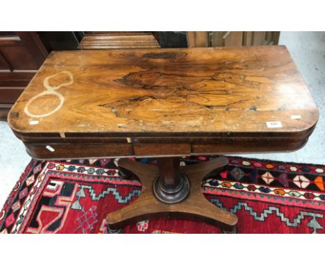 A Victorian rosewood fold over card table on tapering octagonal base to platform quadruped supports and turned feet 91 cm wid
