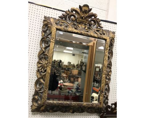 A 19th Century carved oak and gesso decorated Florentine style wall mirror with bevel edged plate, 66 cm wide x 92 cm high