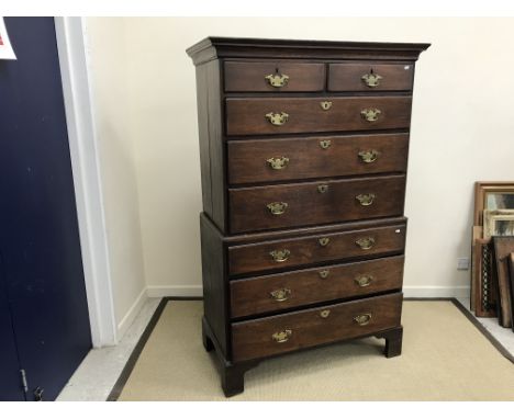 A circa 1800 oak chest on chest, the upper section with moulded cornice above two short over three long graduated drawers wit