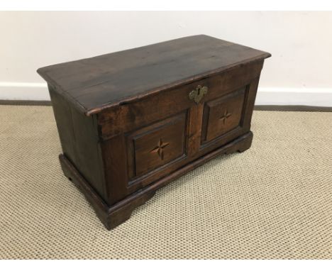 An 18th Century oak miniature coffer, the loose top with moulded edge over two fielded rectangular panels, parquetry inlaid i