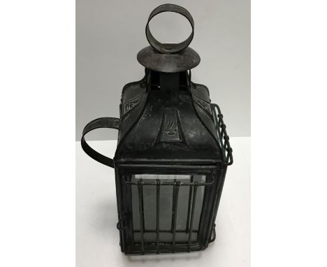 A 17th Century iron and treenware rush light holder 26 cm high, a 19th Century tin and mirrored wall light with single candle