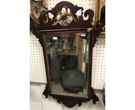 A 19th Century wall mirror with pierced ho ho style bird decoration to top, 41 cm wide x 71 cm high
