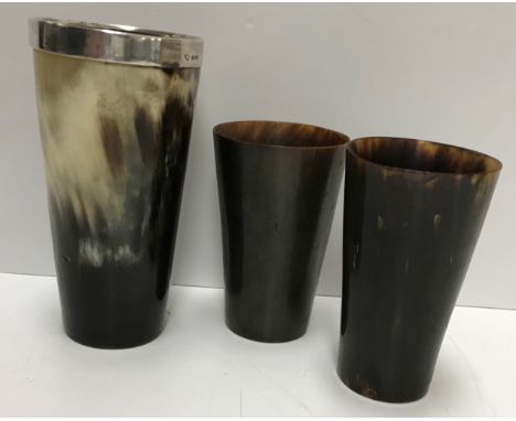 A silver mounted horn beaker, 7.5 cm diameter x 15 cm high and two further smaller beakers, a treen ware lidded bowl, initial