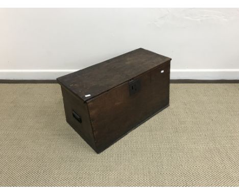 An 18th Century oak trunk of tapered form, the plain top above plain sides and front with later iron carrying handles, 63 cm 