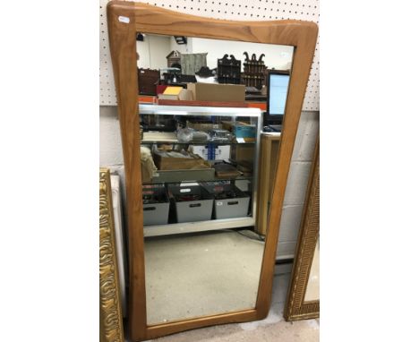 A modern rectangular wall mirror with shaped oak frame, 60 cm wide x 121 cm high, together with a modern gilt framed rectangu