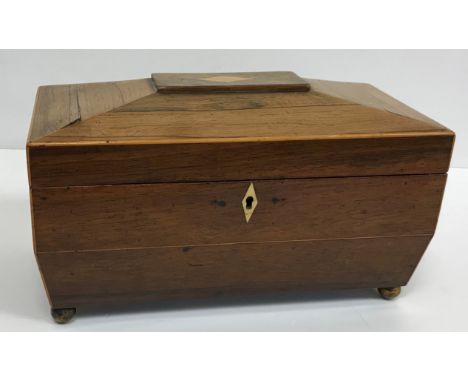 A 19th Century mahogany tea caddy of plain rectangular form, the hinged lid opening to reveal two lidded compartments and cen