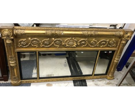 A 19th Century giltwood and gesso triple plate overmantle wall mirror with scrolling foliate and flowerhead medallion decorat