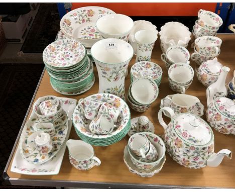 A Minton Haddon Hall part tea and dinner set to include dinner plates, tea cups, two tea pots (varying sizes), various vases,