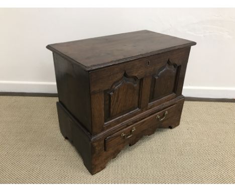 An 18th Century oak coffer bach, the single piece top over two arched fielded panels and single drawer, on bracket feet, 56 c