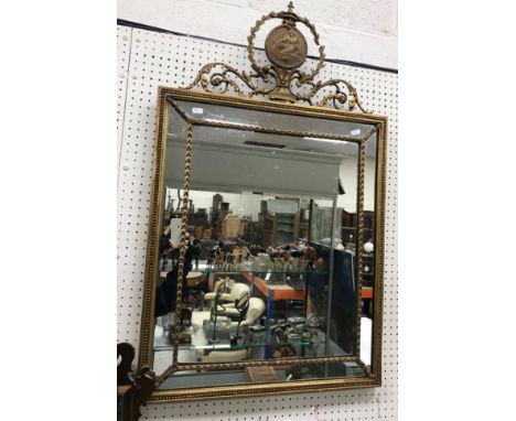 A 19th Century giltwood and gesso framed wall mirror in the George III style, the delicate scrolling foliate medallion decora