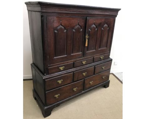 An 18th Century oak cupboard, the moulded cornice above a bog oak and holly parquetry work banded frieze bearing ownership in