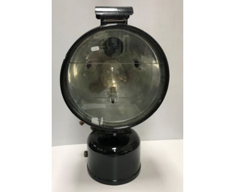 A vintage Tilley floodlight projector lamp, black enameled and converted to electricity, 36 cm diameter x 65 cm high overall