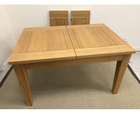 A modern oak extending dining table of plain form, with two leaves, 132 cm wide (unextended) x 92 cm deep x 77 cm high, both 
