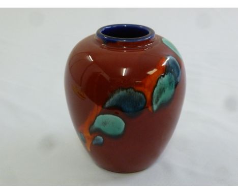 A Poole Pottery vase with abstract designs to the sides, marks to the base