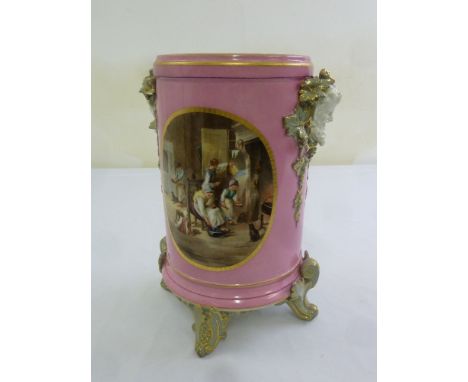A 19th century Continental ceramic jardinière of cylindrical form, pink ground with panels depicting domestic scenes, 33.5cm 