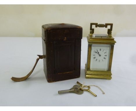 A 19th century brass repeating carriage clock, in original leather carrying case to include keys