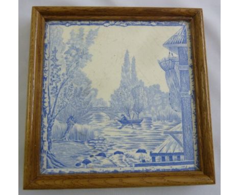 An early 20th century rectangular blue and white decorative tile depicting a fishing scene, 19 x 19cm