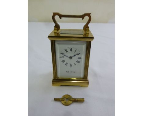 Mappin and Webb brass carriage clock of customary form, enamel dial with Roman numerals, to include key