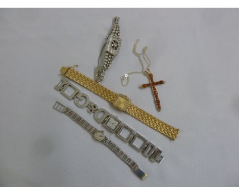 Four ladies dress watches to include D & G, a silver Rotary watch and a crucifix with semi precious stones on a silver chain