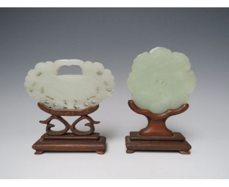 A CHINESE CARVED JADE BUCKLE, with four character mark to one side, raised on a wooden stand, W 9.5 cm, together with a circu