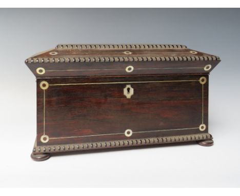 AN ANTIQUE ROSEWOOD SARCOPHAGUS SHAPED TEA CADDY FOR RESTORATION, with mother of pearl and brass inlay, raised on four bun fe