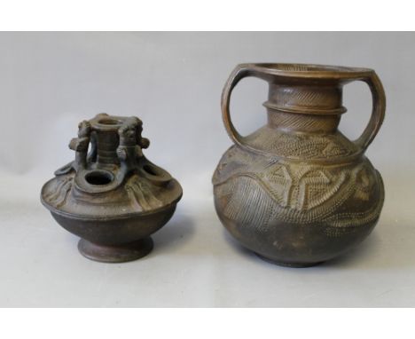 TWO WEST AFRICAN TRIBAL ART NIGERIAN STORAGE POTS, the larger Nupe with twin handles, the smaller Igbo with stylised figures