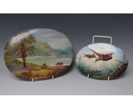 A SMALL EARLY 20TH CENTURY OVAL PORCELAIN PANEL DEPICTING BIRDS IN FLIGHT, signed A.H. WRIGHT and dated 1918, 12.8 x 17.6 cm,