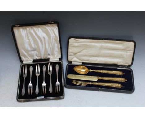 A CASED GILT METAL CHRISTENING SET, consisting of knife, fork and spoon, each having lozenge mark, case W 26 cm together with