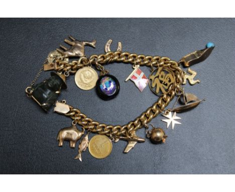 A CHARM BRACELET, on yellow metal bracelet with continental marks to clasp, adorned with several charms including two Russian