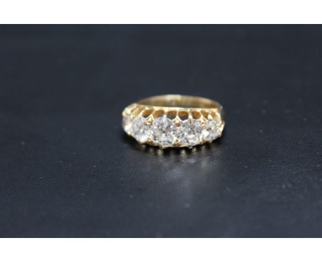 A HALLMARKED 14CT FIVE STONE DIAMOND RING, set with an estimated 3.5 carats of old cut diamonds, the centre stone being an es