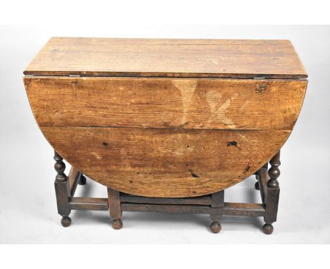 A 19th Century oak Drop Leaf Gate Leg Table with Oval Top, 102cms Wide 