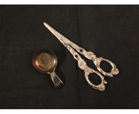 A pair of continental silver grape scissors plus a caddy sifter spoon