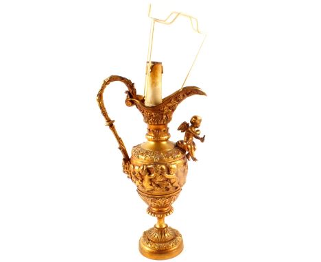 A brass ewer table lamp with cherub decoration