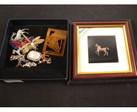 Lot of costume brooches, animal themed and a silver model of a horse in frame