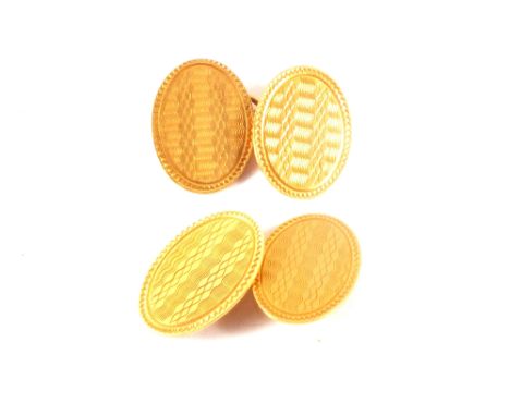 A pair of 18ct gold oval cufflinks with engine turned decoration