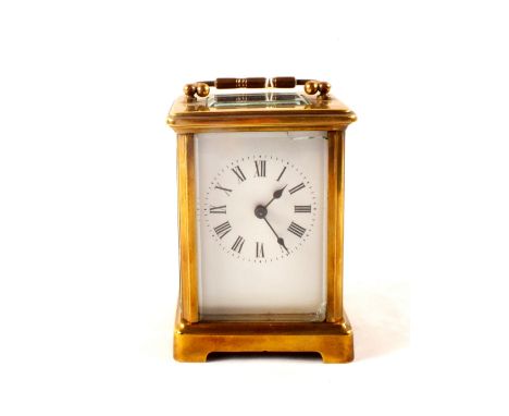 A brass carriage clock with enamel dial (light glass chip)