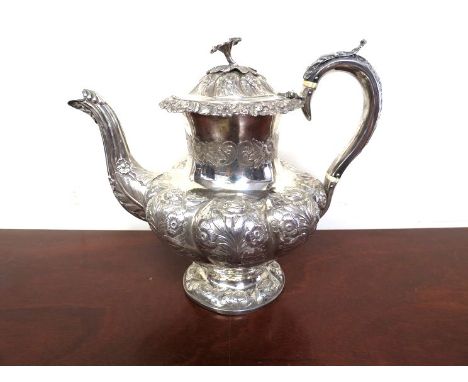 A William IV floral embossed silver teapot with armorial cartouche, makers mark IW, 34cm tall, 1018g