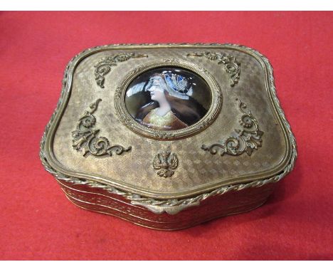 An Ormolu jewellery box with an enamelled circular cartouche of a portrait of a lady with head dress, velvet interior 