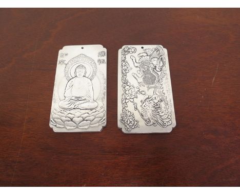 Two Chinese silver ingots depicting dragon and Buddha character marks verso 10cm x 5.5cm, 308g 