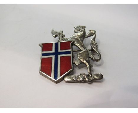 A Norwegian silver brooch/badge, the rampant lion with an axe beside a Norwegian flag in a shield, stamped "Disanza sterling"