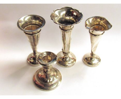 Three silver trumpet vases and a silver candlestick a/f