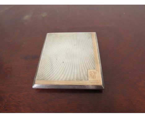 A silver cigarette case with engine turned design, rose gold surround, London 1934, 129g