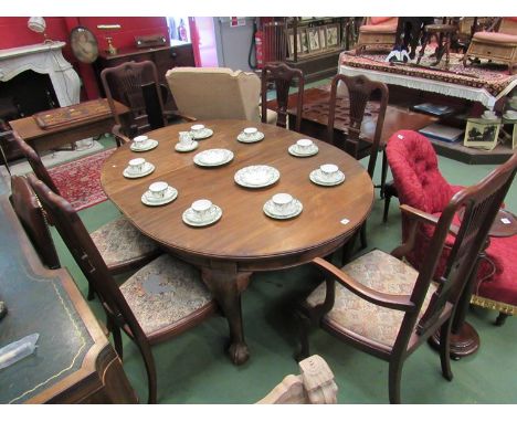 A circa 1900 mahogany extending dining table and chairs, the D-end table on ball and claw feet to castors. A set of six (4+2)